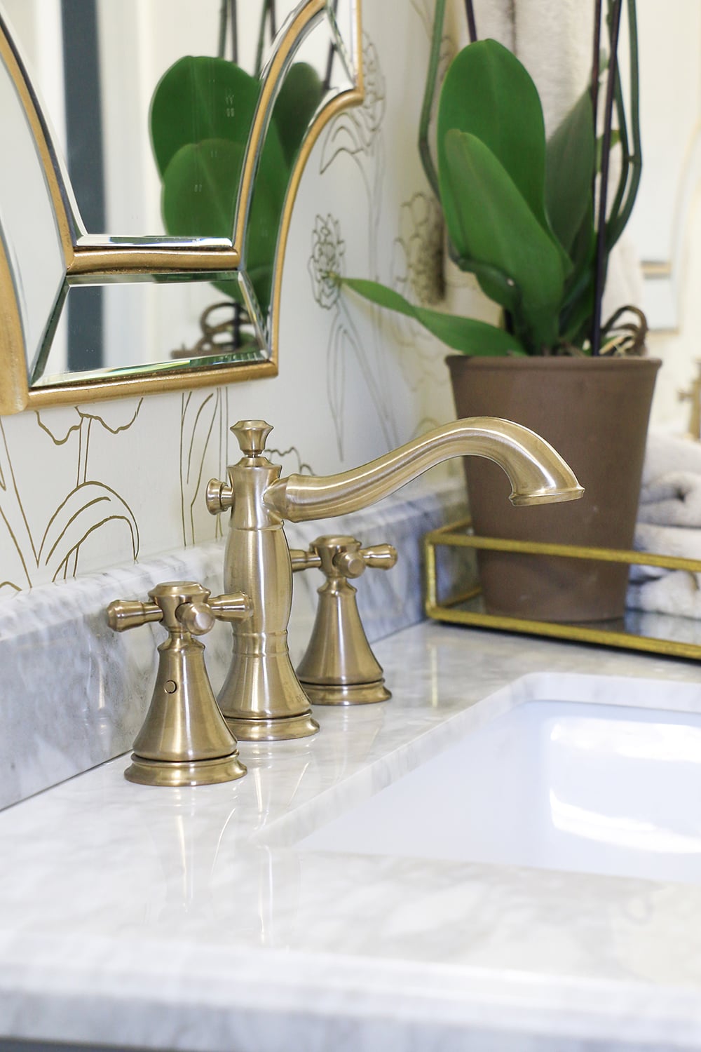 Bathroom sink with gold faucet