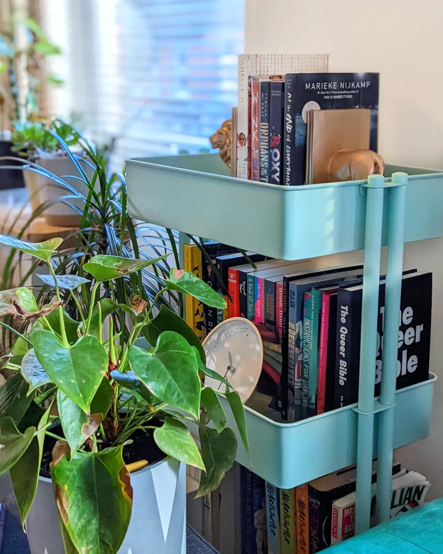A pale blue trolley stocked with books