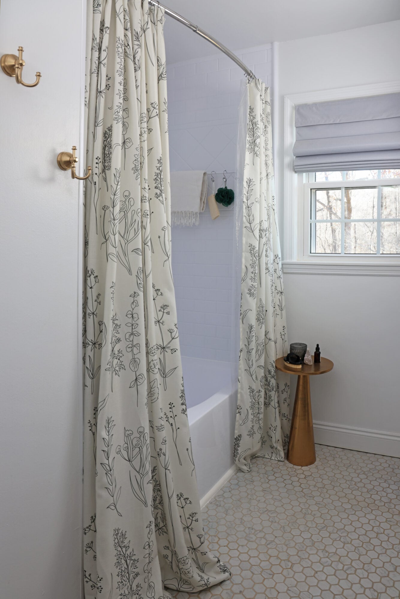 bathroom bathtub with double floral shower curtains