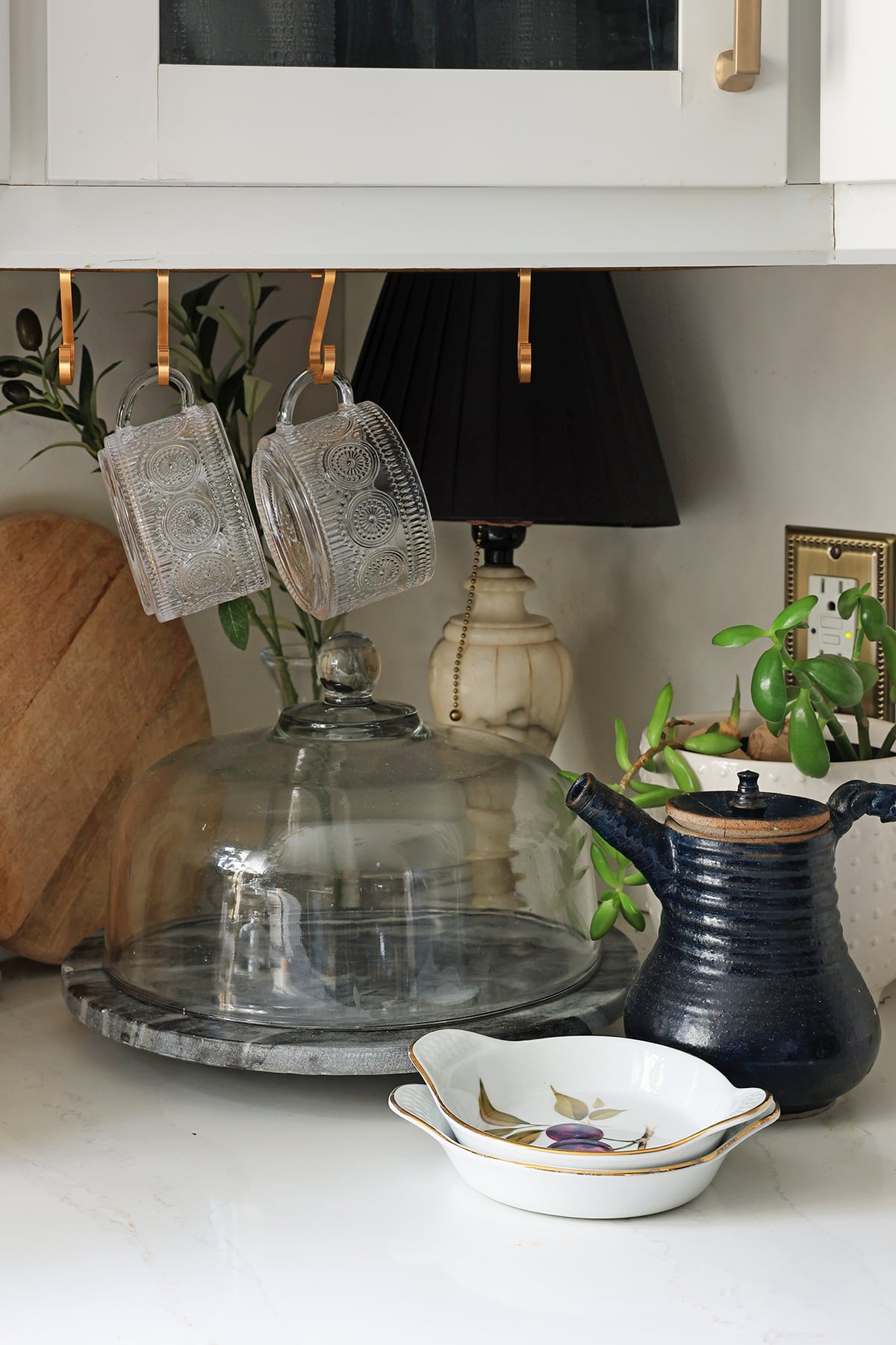 Cake holder and dishes on kitchen counter