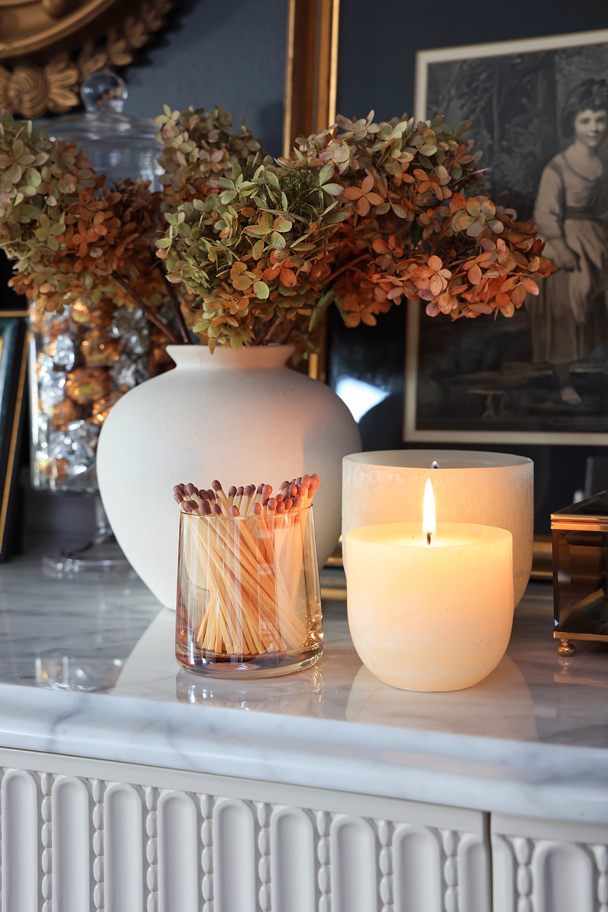 White vase with hydrangeas plus candles and matches