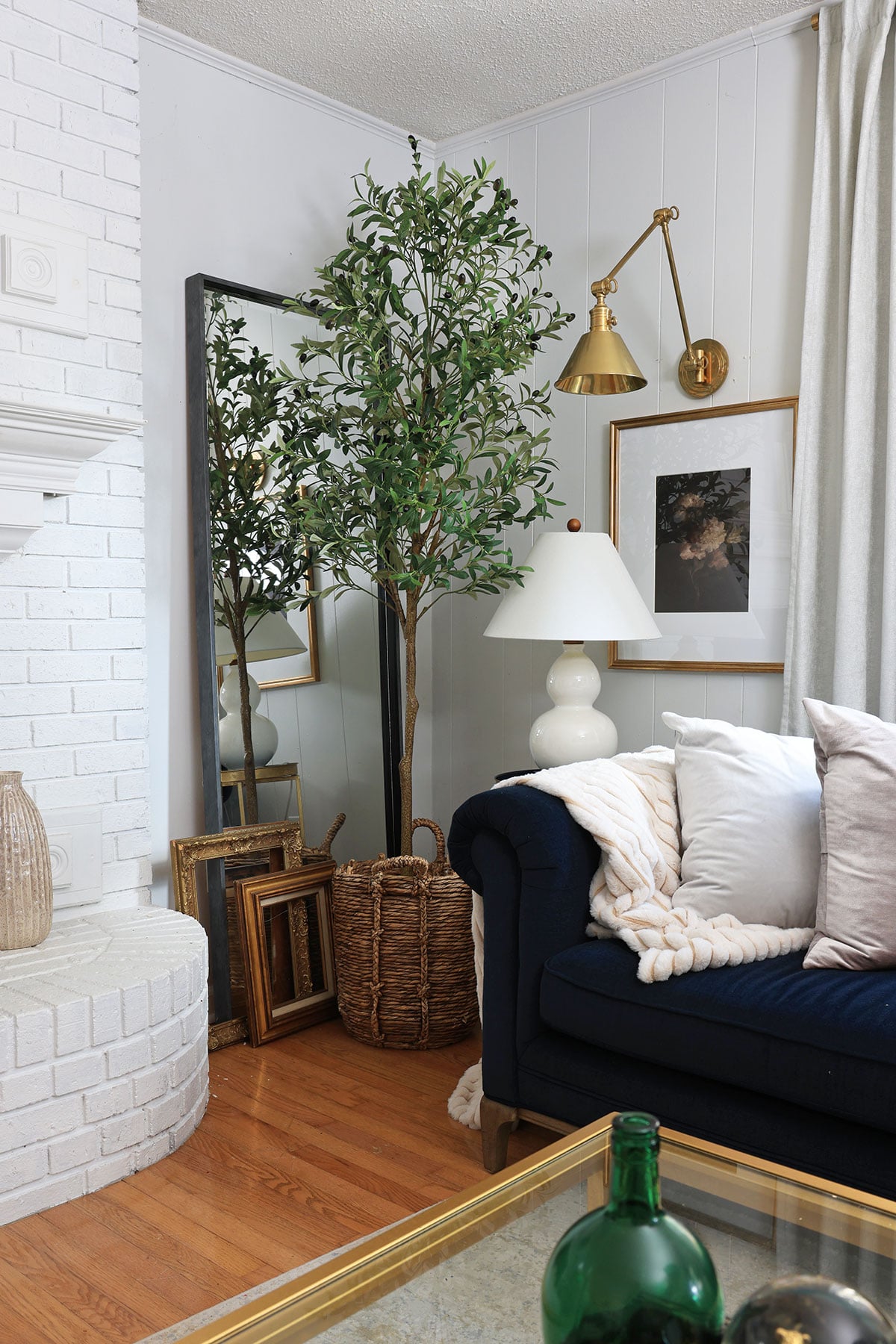 Oversized faux olive tree houseplant in living room