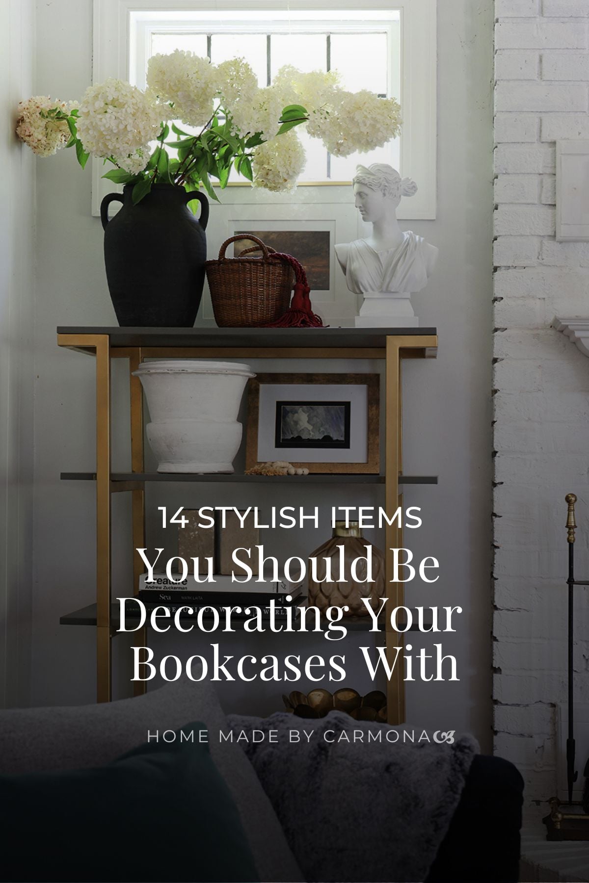 Bookcase with styled flowers vases, statue, basket, and art
