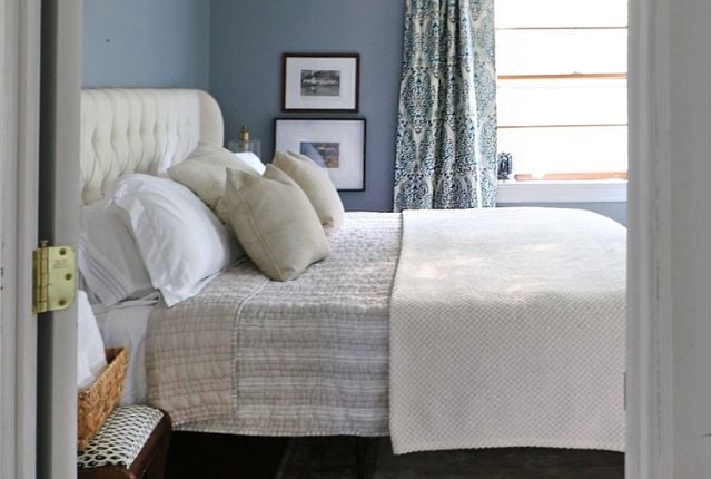 Guest bedroom with lots of plush pillows and spare blankets