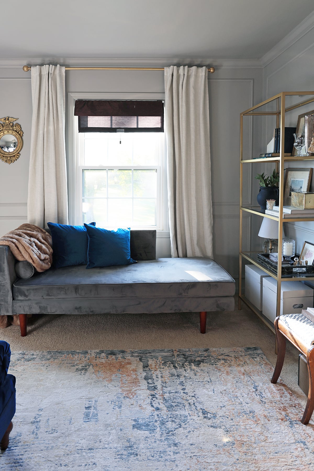 Chaise sofa, a bookcase, and curtains