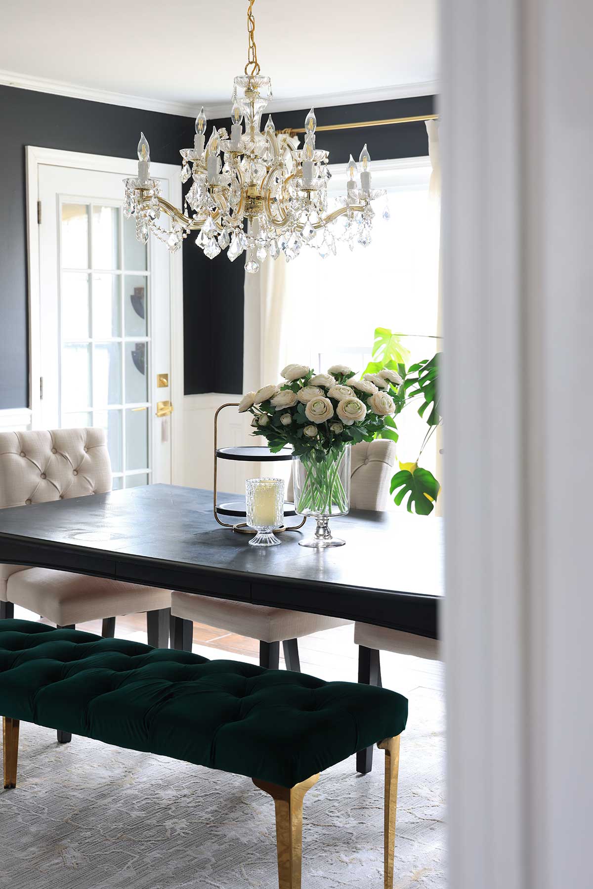 Dining room with chandelier and black dining table