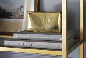 Decorative books being used as a riser on a shelf